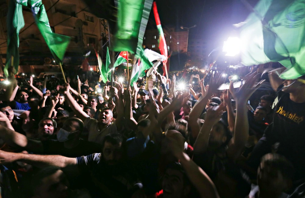 Palestinci slave na ulicama nakon primirja na jugu Gaze, Foto: Ibraheem Abu Mustafa/Reuters